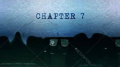 Chapter 7 words Typing on a sheet of paper with an old vintage typewriter.