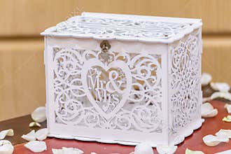 Closeup shot of an elegant wooden white wedding gift box with the writing Mr & Mrs