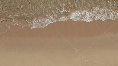AERIAL: Beautiful Generic Tropical Beach Overhead Shot, bird`s eye view of ocean waves crashing against an empty beach