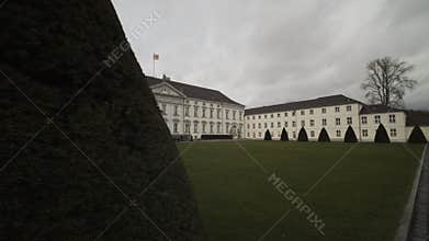 Wide Shot revealing Bellevue Palace in Berlin, Germany with Green Lawn on beautiful Day