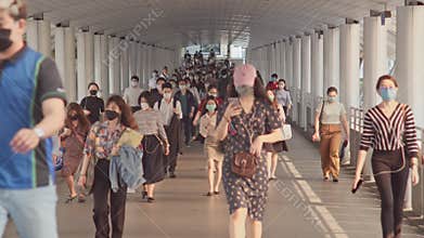 Less crowded Asian people wear face mask walk in pedestrian walkway. Coronavirus disease Covid-19 pandemic outbreak concept