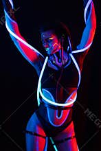 Portrait of a Girl with Glowing Tubes in Neon UF Light. Model Girl with Dreadlocks and Fluorescent Creative Psychedelic