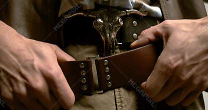 Close up of the belt of a cowboy and the amazing bull on the belt buckle, 4k