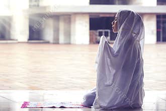 Beautiful woman praying to Allah in the mosque