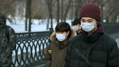 Asian people. Crowd walk street asia. Chinese Masked Man Outdoor City. Covid-19.