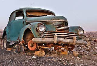Old broken rusty abandoned car