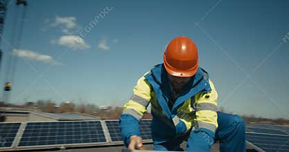 Technician installing solar panel on flat roof