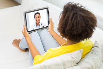 Patient having video chat with doctor on tablet pc