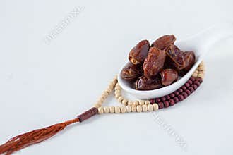 Food Ramadan  date Sweets mixed of dried fruits and nuts Glass Tea with a rosary and the Quran, Concept: month fasting culture
