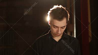 Handsome man says yes and nods his head against backlight background