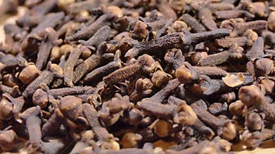 cloves on wooden board. spices and food ingredients. rotate macro shot