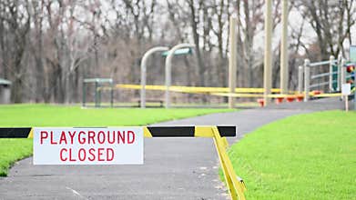 Barrington, IL / USA - April 10 2020: Closeup of closed playground sign at park during corona virus pandemic