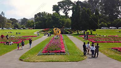 People visiting and relaxing inside beautiful Golden Gate Park filled with flowers and gardens
