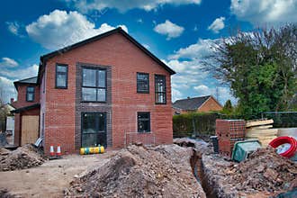 A detached house under construction on a building site in the UK, closed during the UK Government coronavirus lockdown
