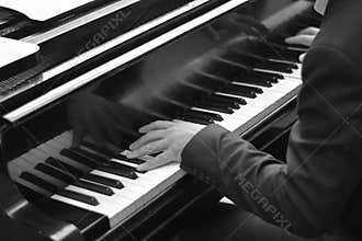 The pianist touches the piano keys with great skill