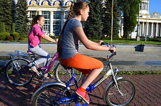 Ukraine, Kiev, May 11, 2015. Two teenage girls ride bicycles.