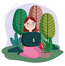 Young woman in grass with potted plants trees