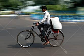 A man is riding a cycle in kolkata at Dharmatala.