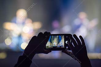 Fan holding smartphone during a concert
