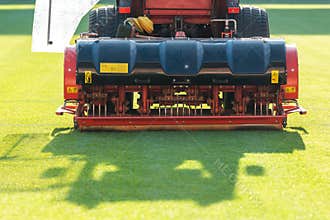 Tractor aerating a soccer field