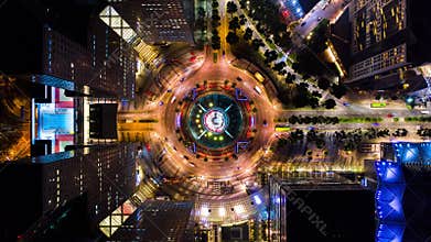 4K Hyperlapse time-lapse of car traffic transport at roundabout fountain of wealth in Singapore, drone aerial top view, fly upward