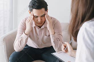 Male Asian patient with psychologist women examination consulting and psychotherapy by the physician in the clinic. psychiatrist