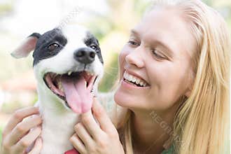 Happy dog owner petting and talking to her dog. Animal communication