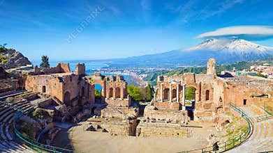 Morning view of ancient Greek theatre in Taormina on background of Etna Volcano, Sicily, Italy