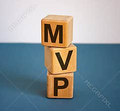 Concept word `MVP` on cubes on a beautiful blue background. Business concept