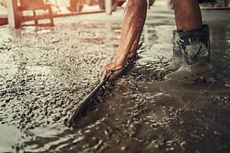 closeup hand of worker plastering cement for building house in concstruction site