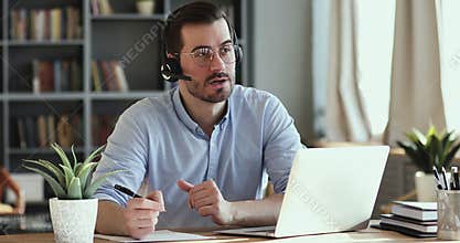 Confident young handsome businessman holding video call with clients.