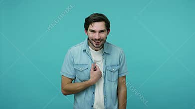 Wow is that me? Handsome positive guy in jeans shirt pointing himself and looking around with amazement