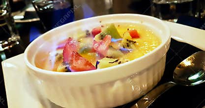 Catalan cream with fruit and flame on top, concept of nutrition