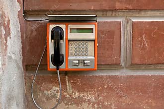 Public phone on grunge wall