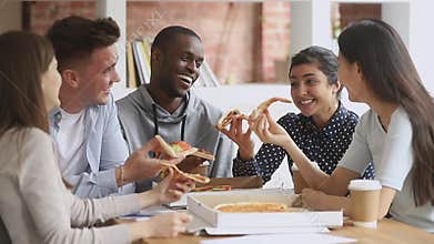 Happy mutiethnic young students people having fun share pizza