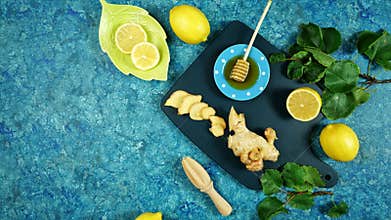 Ginger, honey and lemon herbal tea preparation flat lay creative concept layout.