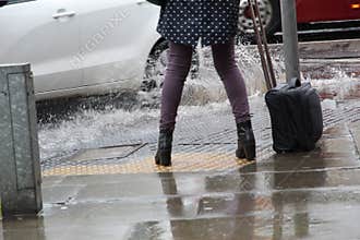 Woman Getting Splashed in the Rain