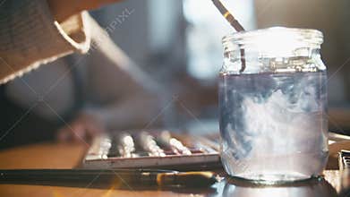 Watercolor painting female hand washing brush jar