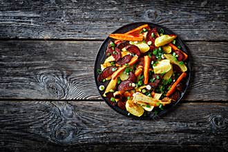 Roasted veggies on a black plate