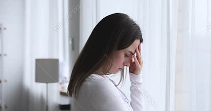 Upset worried young brunette woman thinking of problems.