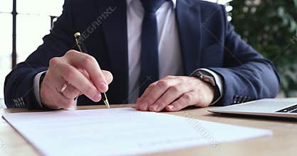 Focused executive ceo signing report after checking information.