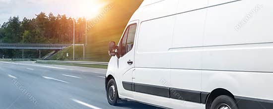 White modern delivery small shipment cargo courier van moving fast on motorway road to city urban suburb. Busines distribution and
