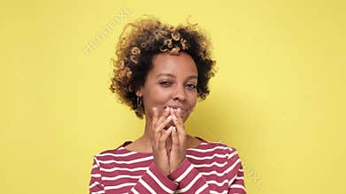 Cunning african woman looking aside holding hand under chin indenting to realize tricky plan.