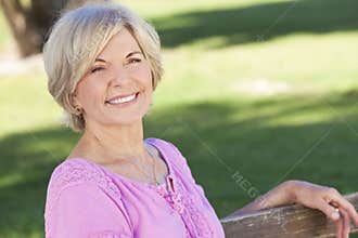 Happy Senior Woman Sitting Outside Smiling