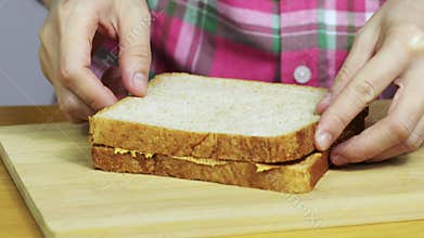 Woman making a peanut butter sandwich