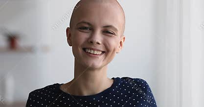 Close up bald woman standing indoor smile look at camera