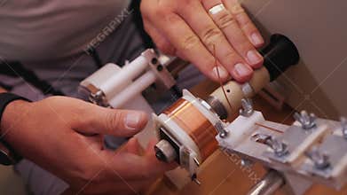 Coil winding machine reeling wire making electronic component - close up