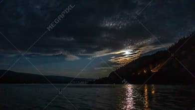 Cloudy sky seen from the shore of Okanagan lake at night British Columbia Canada