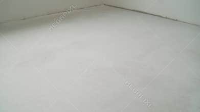 Floor leveling works. Fresh concrete floor of a construction site