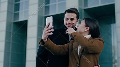 Two positive people communicate with friends by videocall .